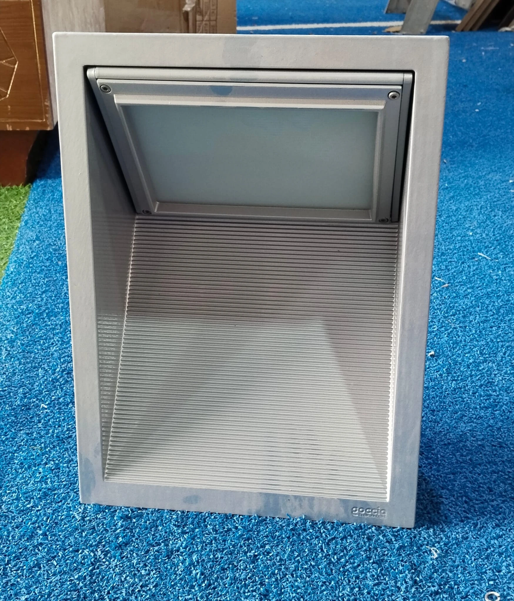 Outdoor Wall-recessed light fixture made of metal with a textured, louvered face